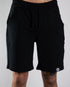 Kurze Raver Hose in schwarz mit Technostoff Weblabel am Hosenbein, von vorne fotografiert